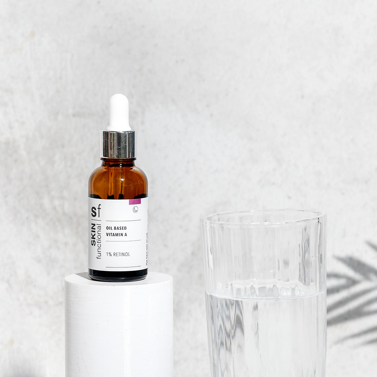 SKIN Functional Oil Based Vitamin A with details skincare product on a grey background