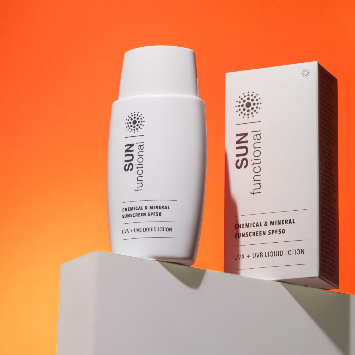 Sunscreen bottle and packaging with 'SUN functional' branding on an orange background