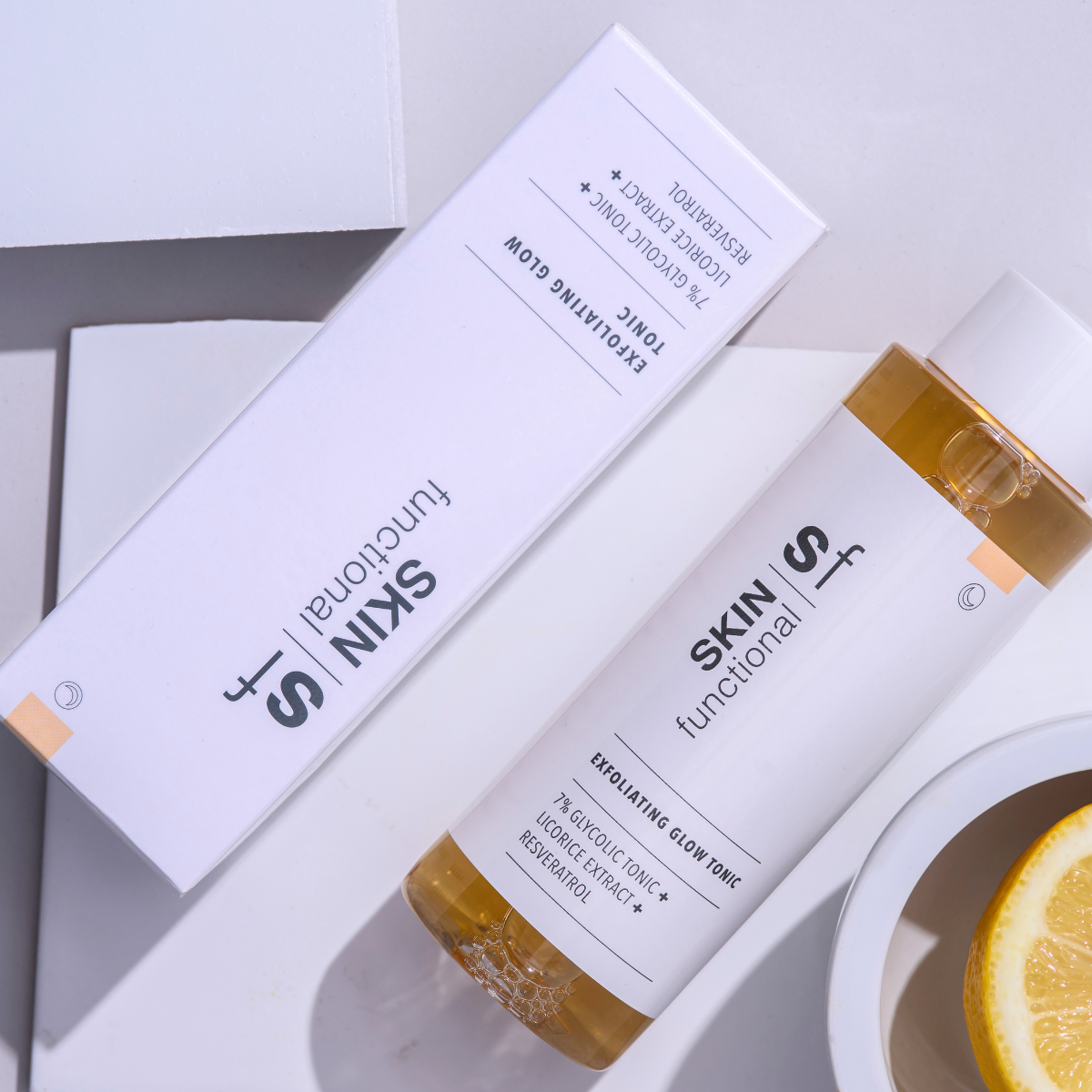 Skin Functional Exfoliating Glow Tonic bottle held by a hand with product details on a light background