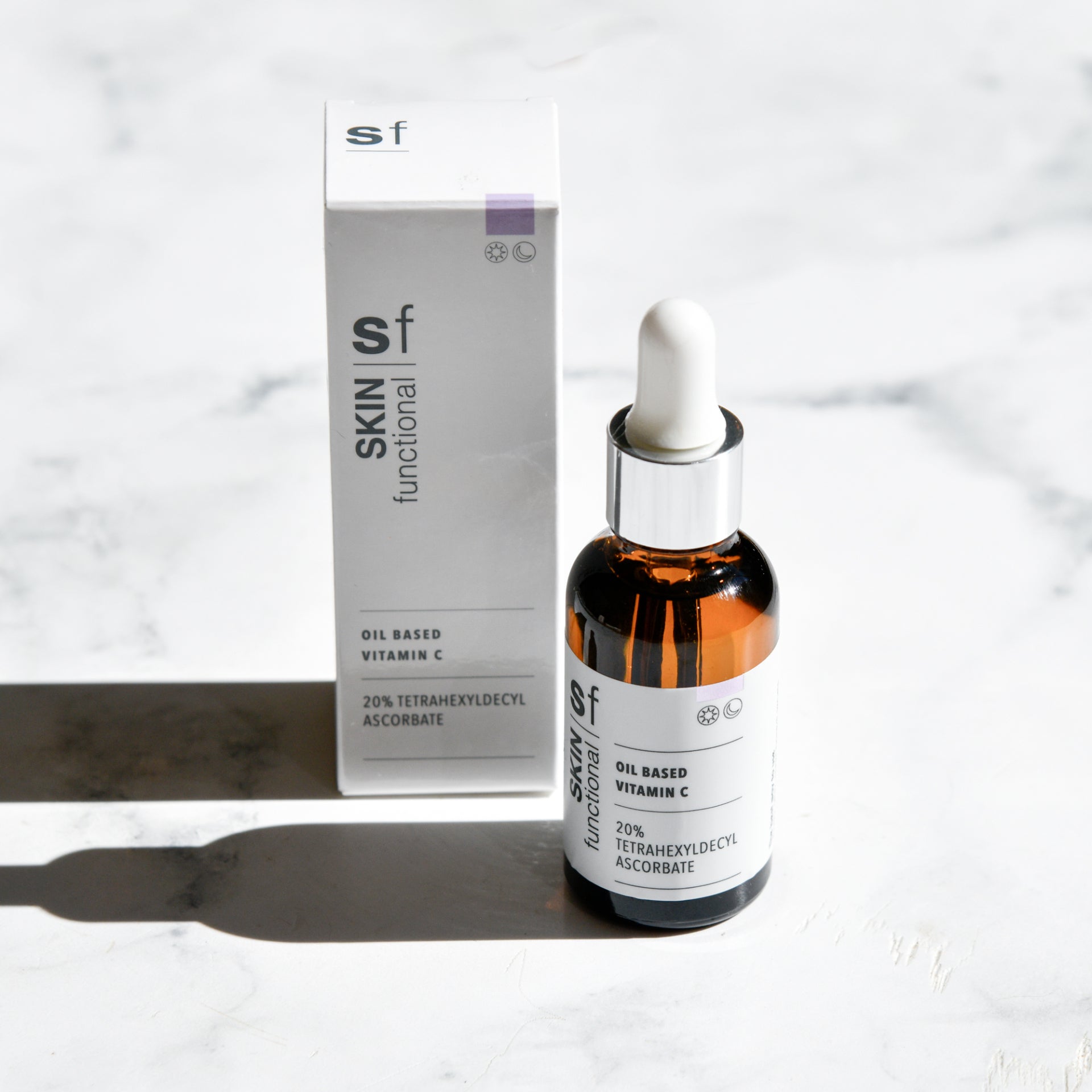 SKIN Functional Oil Based Vitamin C with details skincare product on a grey background