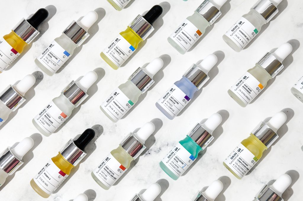 Pattern of Skin Functional
 skincare dropper bottles on a light background