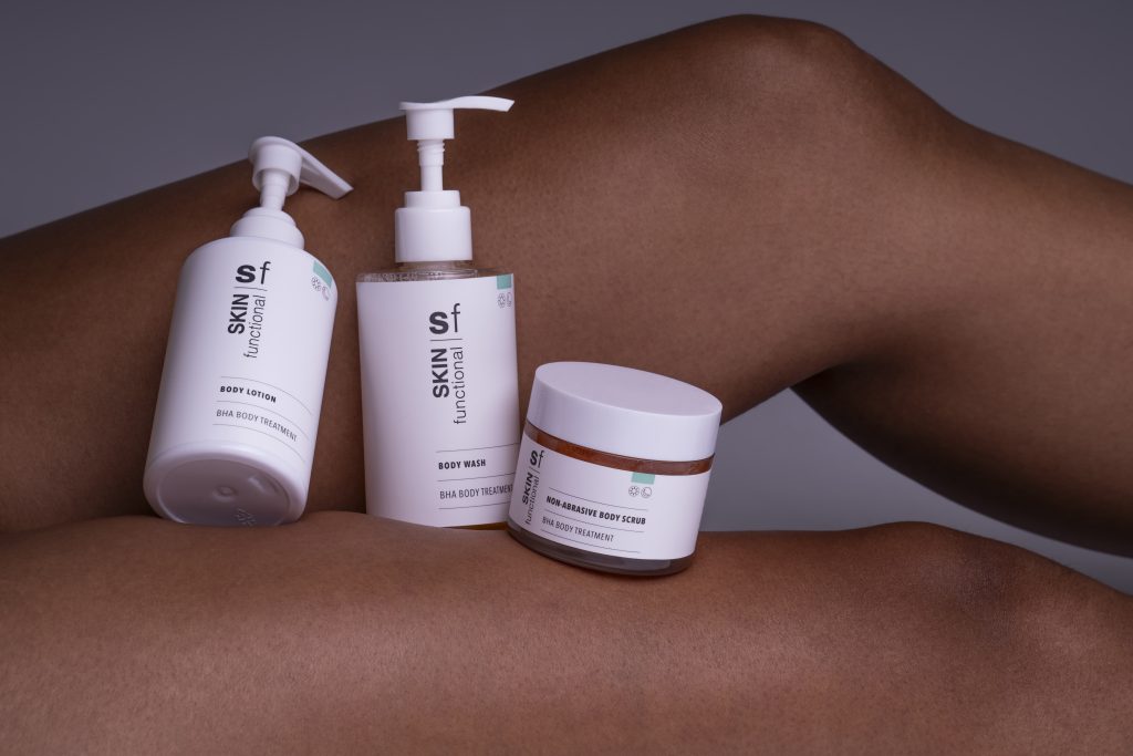 Three Skin Functional skincare products on a person's leg with a neutral background