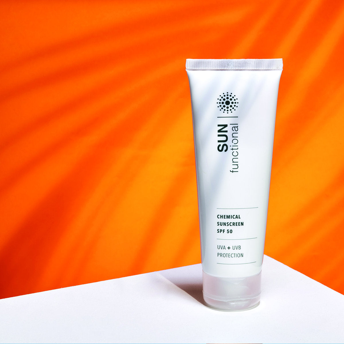 SKIN Functional Chemical Sun Screen SPF 50 with details skincare product on an orange background
