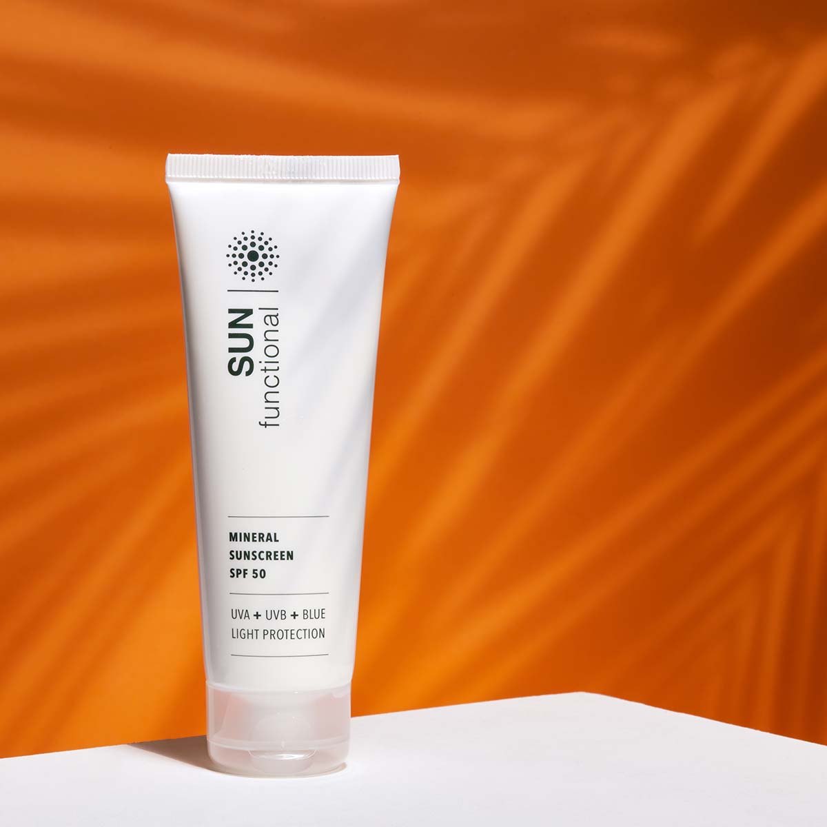 SKIN Functional Mineral Sunscreen SPF 50 with product details skincare product on a light gray background
